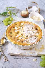 Green grape clafoutis from almond flour, almonde petals dressing