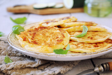 Zucchini fritters. Vegetable squash pancakes, basil dressing