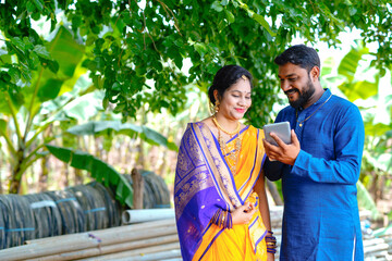 Indian rich farmer and his wife in the field