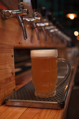 Vertical close up of a beer mug at the tap