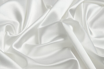 Obraz premium White color silk fabric background, top view. Smooth elegant white silk or satin luxury cloth texture can use as abstract background with copy space 