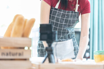 close up woman body blogger making a bread, and recording stream live video online from camera