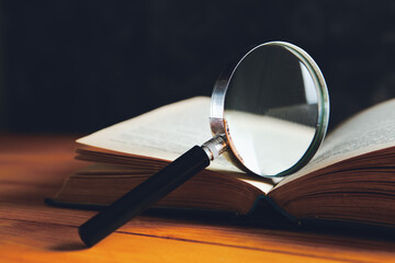 magnifying glass and book on the table