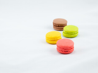 Sweet and Colorful four macaroons lying togehter on white background