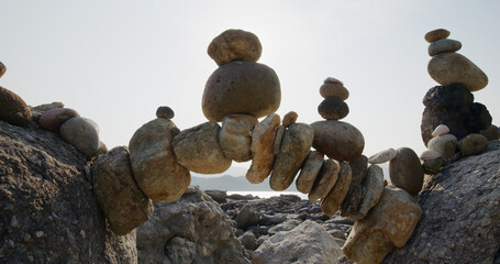 Fototapeta na wymiar Arch of pebbles in balancing on the sea coast