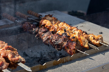 fried meat in large pieces grilled barbecue shahlyk kebab smoke outdoors street food