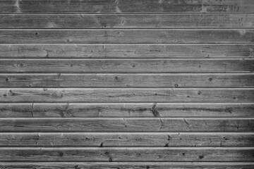 Front view of weathered gray wood boards wall. High resolution full frame textured background in...