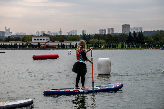 athletes ride on inflatable boards in open water 