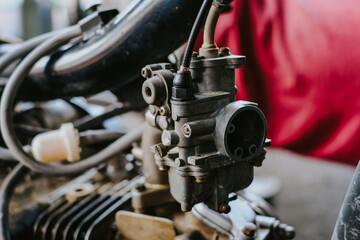 Fototapeta na wymiar Clean the carburetor with dirt on the motorcycle engine and repair it.