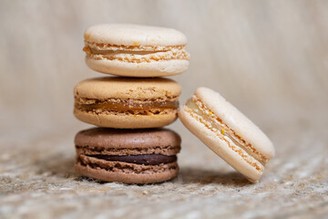 french Colorful Macarons close up Colorful Pastel Macarons on beige Background Brown Macaron Sweet and colourful french macaroons pastry