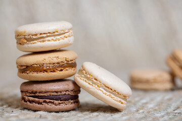 french Colorful Macarons close up Colorful Pastel Macarons on beige Background Brown Macaron Sweet and colourful french macaroons pastry