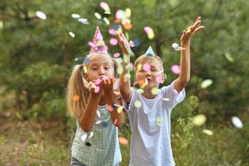 happy birthday children with confetti on outdoor bithday party