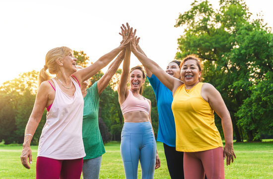 Senior Women Training With Fitness Coach At Park