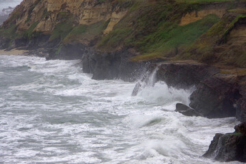  Section of the rough and wild Central California coast on a cloudy and foggy early summer day