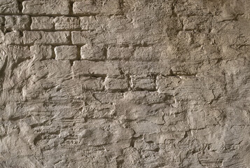 Old brick wall. Textured wall surface with traces of cement. Painted wall.