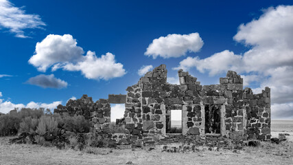 Deep blue sky over a colorless stone building ruin