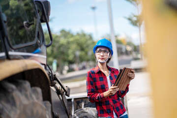 A female engineer is inspecting work at the construction site.