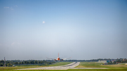 Fototapeta premium Airplane landing on the airport. Perfect view on the airplane with different high.