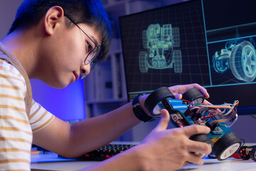 An Asian nerd is assembling a model based robot.