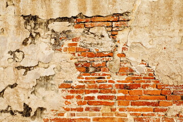 Old brick wall with peeling paint