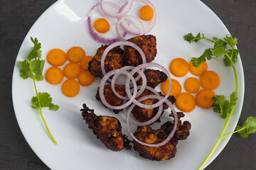 Famous South Indian non veg appetizer snack- chicken 65. Top view of Indian non veg food. Side dish for rice, Chapati, Paratha. coconut oil Deep fried chilli chicken south indian style...