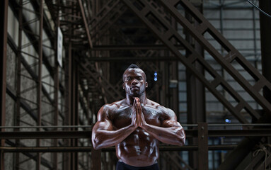 Fototapeta na wymiar Bare-chested athlete in prayer position