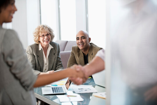 Business people shaking hands in office