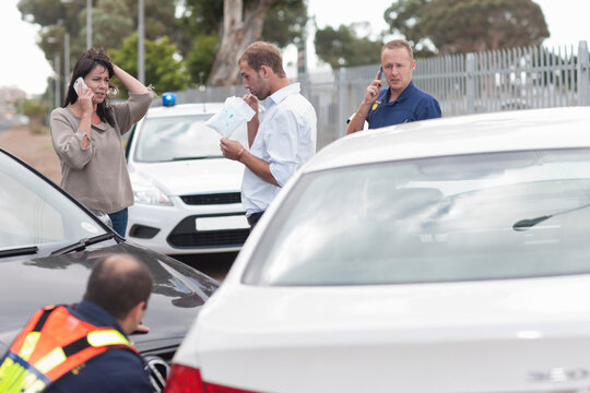 Man being breathalyzed at scene of car accident