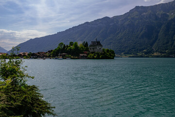View of village and former castle on Lake Brienz in swiss village Iseltwald