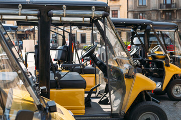 An electric open car for transportation of tourists, coronavirus covid-19 lockdown, empty street in old town.