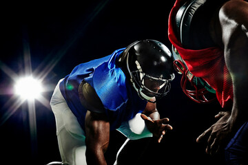 Close up of two american footballers playing head to head © Image Source Limited