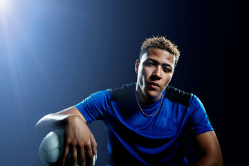 Portrait of young male soccer player with football © Image Source Limited