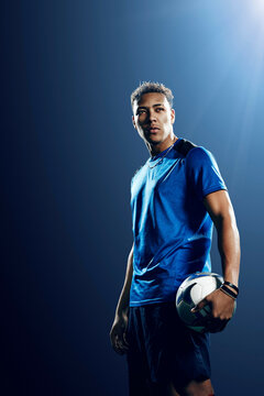 Portrait of male soccer player with football