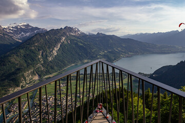 Aerial view of Interlaken, Swiss Alps and lake Thun from Harder Kulm View point with paragliders...