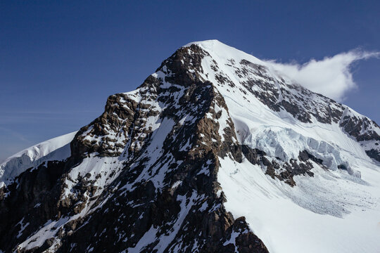View of Monch and Eiger mountain summit with glacier and clouds from Jungfraujoch sphynx observatory
