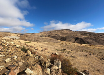 The yellow grassland and Andes mountains under a clear blue sky in a sunny day of autumn. 