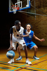 Fototapeta premium Basketball players playing on court