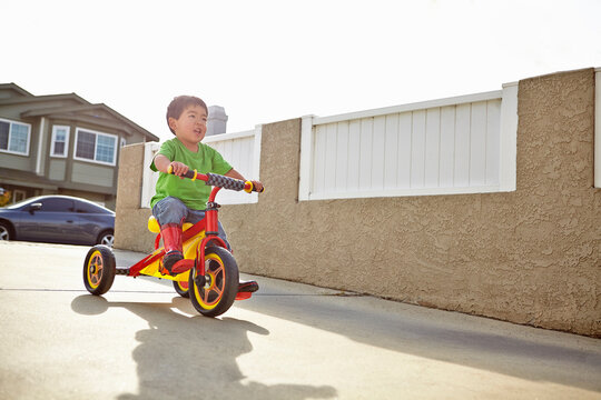 Boy cycling on driveway