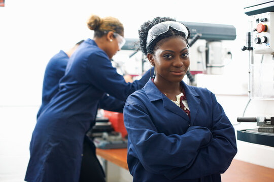 Portrait of female student in college metalwork workshop