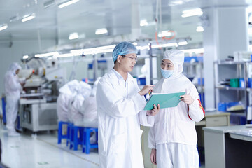 Workers having discussion in ecigarette factory