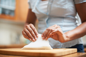 Obraz na płótnie Canvas Womans hands making pastry on chopping board