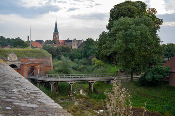 Fototapeta na wymiar Church and town of Domitz behind the wooden bridge of the historic fortress, cityscape and landscape on the river Elbe in northern Germany, Europe