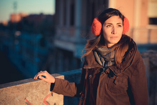 Mid adult woman wearing red ear muffs on city roof top