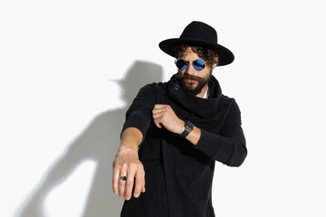 casual man pulling his sleeve with attitude