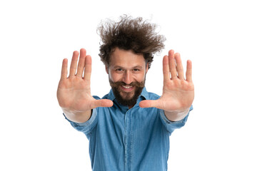 handsome casual man showing his palms at the camera