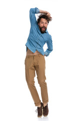 Fototapeta premium handsome casual man jumping with one hand on his head
