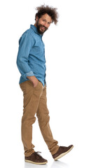 casual man stepping to side and holding hands in pockets