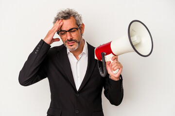 Middle age business man holding a megaphone isolated on white background  being shocked, she has...