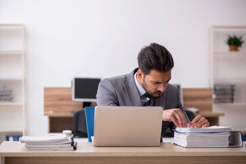 Young male employee working in the office