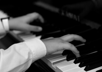 hands of a person playing the piano